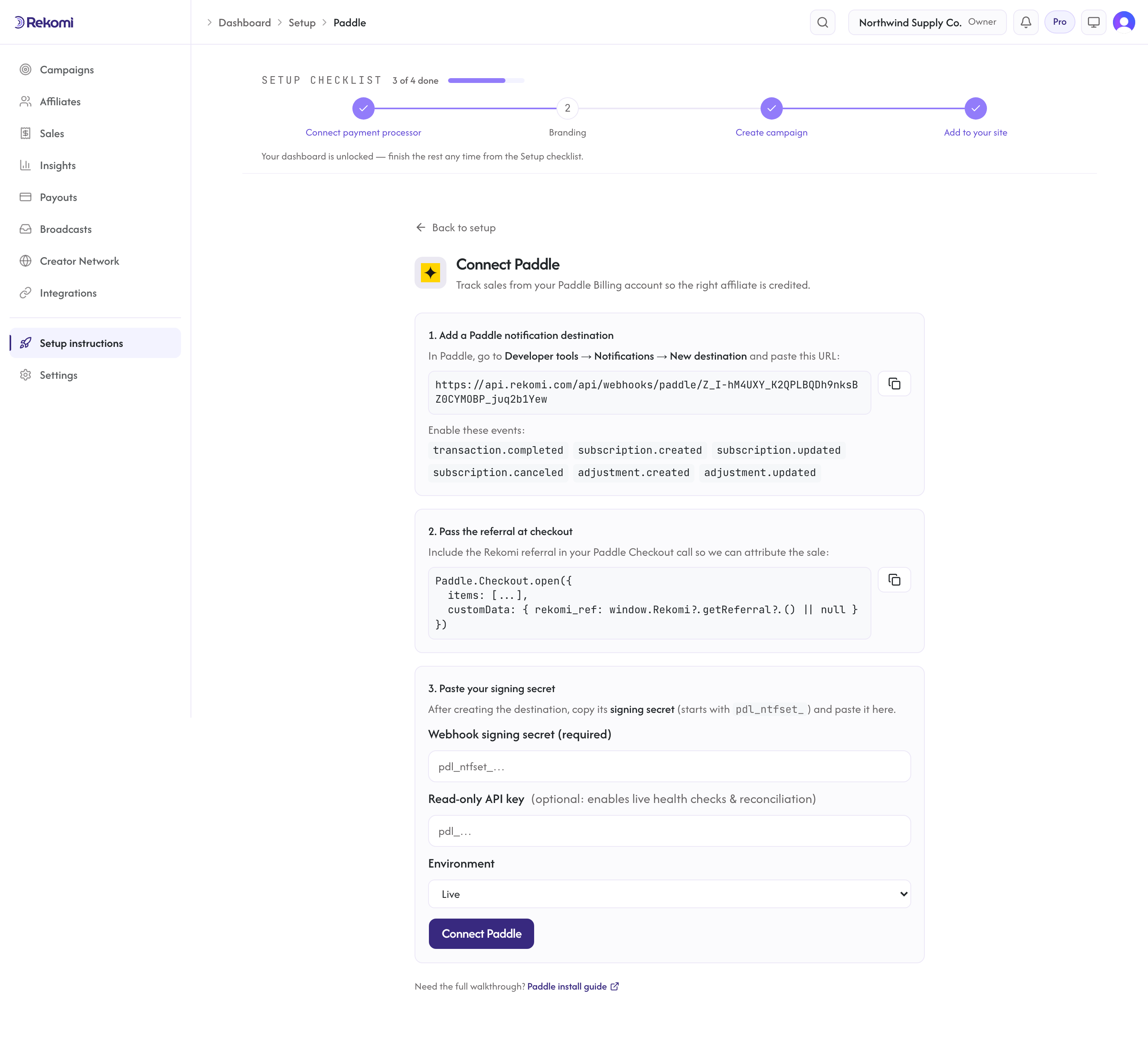 The Connect Paddle page in Rekomi showing the per-workspace webhook URL, events to enable, and the signing secret field