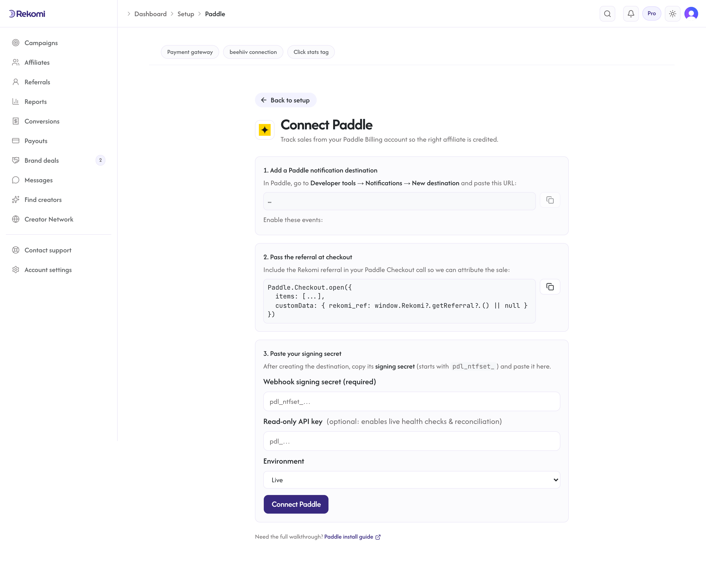 The Connect Paddle page in Rekomi showing the per-workspace webhook URL, events to enable, and the signing secret field